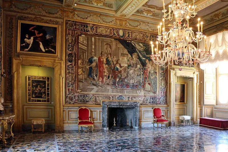 The Chapel Room, a frescoed wall above a stone fireplace and red chairs