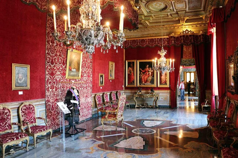 The Room of the Throne, hung with red damask, chandeliers down its length